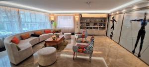a large living room with a couch and chairs at Tuzla Garden Hotel & Spa in Tuzla