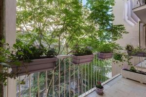 a balcony with potted plants on a railing at Ninuphar Maison - alloggio per uso turistico in Rome