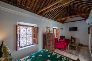 a room with a bed and a window at Riad Lella Chama in Chefchaouene