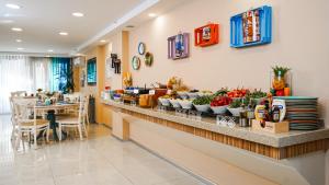 a restaurant with a counter with fruits and vegetables on it at Tuzla Garden Hotel & Spa in Tuzla