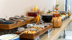 a buffet with baskets of food on a table at Tuzla Garden Hotel & Spa in Tuzla