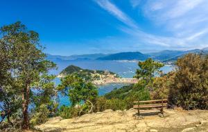 a bench sitting on top of a hill overlooking the water at Lovely Apartment In Sestri Levante in Sestri Levante