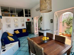 a living room with a table and a blue couch at La Casa di Bubi in Anacapri