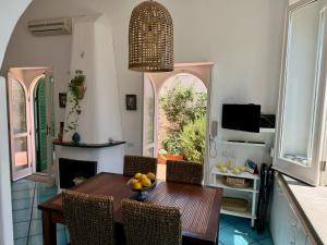 a dining room with a table with a bowl of fruit on it at La Casa di Bubi in Anacapri