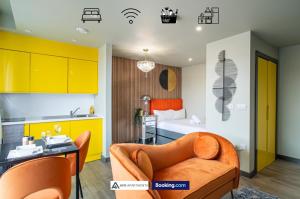 a kitchen and a living room with a couch and a bed at Exquisite Central Suites Sheffield in Sheffield