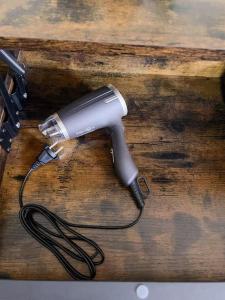 a blow dryer on top of a wooden table at Charming Rustic Beach House Hideaway in Klaipėda