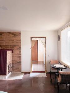 a room with a door and a table and a brick wall at Charming Rustic Beach House Hideaway in Klaipėda