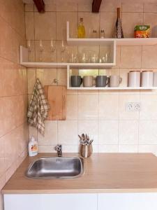 a kitchen with a sink and a counter top at Charming Rustic Beach House Hideaway in Klaipėda +21 photos