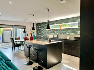 a kitchen with a kitchen island in a room at Beachy House St Andrews in St. Andrews