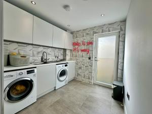 a laundry room with a washer and dryer at Beachy House St Andrews in St. Andrews