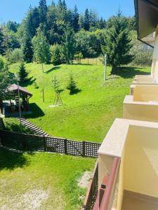 a view of a green field with a fence at Ideal Predeal in Predeal +58 photos