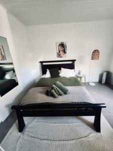 a bedroom with a bed with green sheets and pillows at Rear Garden Suite in Sydney +7 photos