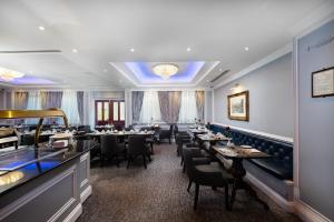 a large dining room with tables and chairs at Gem Fitzrovia Hotel in London