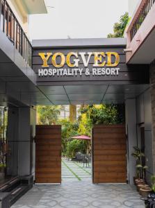 a sign for a yoga hospital facility and resort at Yogved Hospitality & Resort in Rishīkesh