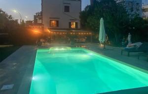 a swimming pool with blue lights in front of a house at Stunning Home In Anzio With Kitchen in Anzio