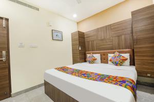 a bedroom with a large bed in a room at FabHotel MRV Inn in Chennai