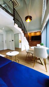 a room with a table and chairs and a staircase at Apartamenty Wielka Odrzańska Centrum in Szczecin