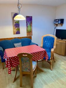 a dining room with a table and chairs and a couch at Nordsee 410 in Wangerooge