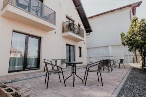 a patio with chairs and tables on a building at Aparthotel Plevnei2 in Cluj-Napoca