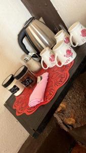a table with coffee cups and shoes on it at La Villafranca del Cid in Zitácuaro