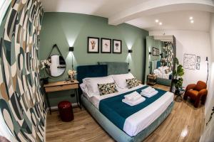 a bedroom with a bed with a blue and green wall at Residenza dei Papi - Luxury City House in Castel Gandolfo