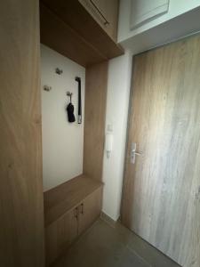 a hallway with a large wooden door with aigunigunigunccessccess at Lelle Resort Apartman in Balatonlelle