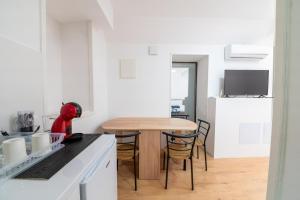 a kitchen with a table and a dining room at Colours Plus in Sarajevo