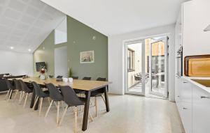 a dining room with a table and chairs at 5 Bedroom Awesome Home In Ebeltoft in Ebeltoft