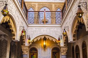 a hallway in a building with a chandelier and a ceiling at Riad Sidi Fatah in Rabat