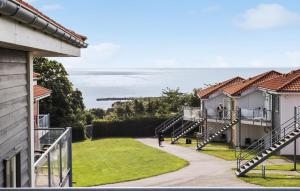 a person walking down a walkway between two houses at Gudhjem Søpark Lejl 28 in Gudhjem +14 photos