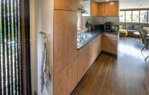 a kitchen with wooden cabinets and a counter top at Awesome Stacaravan In Tzummarum in Tzummarum