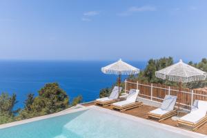 a villa with a pool and a view of the ocean at NeRó Villas Lefkada in Tsoukaladhes
