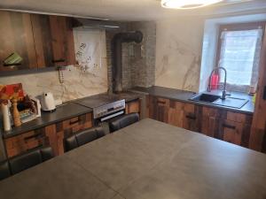 a kitchen with a table and a counter top at Appartement Nax in Nax