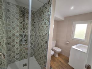 a bathroom with a shower with a toilet and a sink at El balcón a San Felipe in Cuenca +18 photos