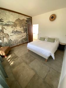 a bedroom with a bed and a painting on the wall at Calma Blanca in Castries +5 photos