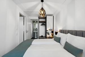 Letto o letti in una camera di GLANDON Rooms Haldenhof - Self-Check-In