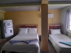 Postel nebo postele na pokoji v ubytování Posada Paradise Suite