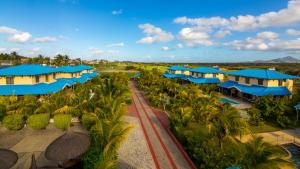 an aerial view of a resort with blue umbrellas at Orchid Villas Mauritius in Belle Mare
