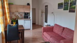a living room with a couch and a table and a kitchen at 1-Zimmer-Apartment-2-Hochparterre in Lübeck