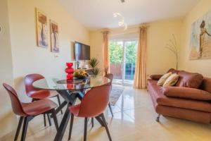 a living room with a table and chairs and a couch at La Dama in Novi Vinodolski