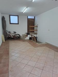 a room with a tiled floor and two bikes at Casa Mandorle in Ugento