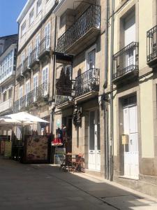 a building with balconies on the side of a street at Estudios rúa Maior, 49-2A in Sarria