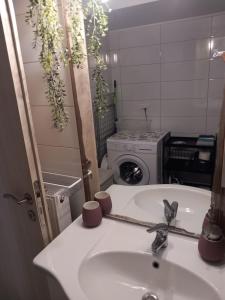 a bathroom with a sink and a washing machine at G&G home Antikalamos in Andikálamos +30 photos