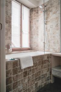 a bathroom with a tub and a shower at Auberge Buissonniere in Gresse-en-Vercors