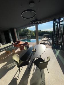 a living room with a table and chairs and a pool at Villaconcept57 in Abreschviller