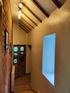 an empty hallway with a door and a window at Hebron Rural converted chapel in Nantglyn