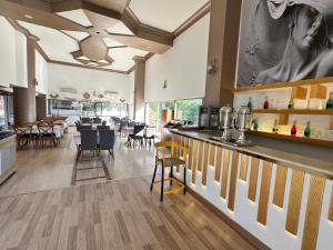 a restaurant with a bar with chairs and tables at Silver Tower Family Apart Otel in Kuşadası