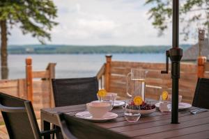 a wooden table with plates of food on it at La vie O-Lac Magog in Sherbrooke