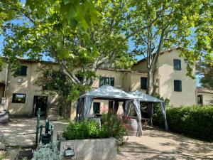 a house with a tent in front of it at domaine de montbuisson in Tourbes
