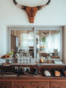 a kitchen with a counter with food on it at Hotel Mas Des Barres in Saintes-Maries-de-la-Mer